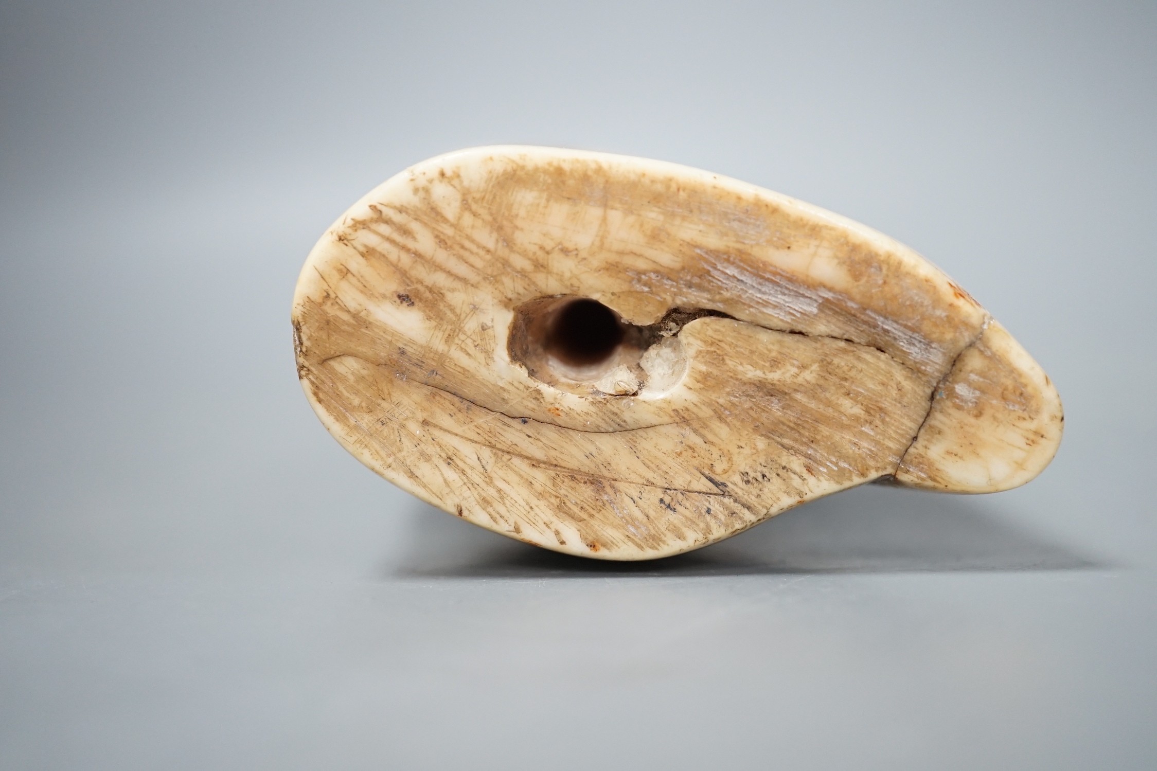 A 19th century scrimshaw whale tooth, 16cm